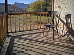 The chair sits peacefully with a grand view, witness to the tragedies of flood, Indian attacks, and disease.  Harsh pioneer life in Grafton, UT.