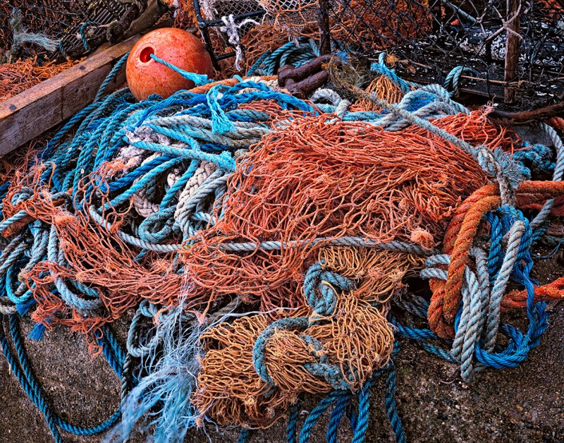 A profusion of color marks the tools of the lobster trade.  Rope, floats, and lobster traps on the pier in Uig, Scotland, UK.