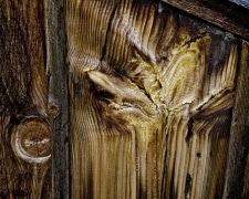 Rough hewn lumber reveals an inner form of a butterfly or flower from the wood grain.  Do you see this or something else?  Perhaps a mitten? Wall Street Mill, Joshua Tree National Park, CA.