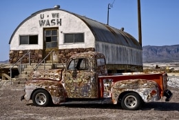 Outside Death Valley, the U * We * Wash Laundromat seems totally out of place.  A truck stands guard.  Tecopa Hot Springs, CA.