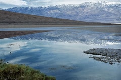 Before the National Park Service put in a huge parking lot, Badwater in Death Valley National Park, CA, was a thing of beauty.  Telescope Peak in the distance reflects from the small pool that used to collect here at the lowest place on the North American continent.  Snow on the peak equates to winter in Death Valley.