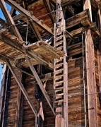 Remnant of a former age, this stamp mill has been idle for many decades.  Still fit for birds, a nest can be seen in the top of the structure.  Never painted but preserved by the desert dryness, this mining artifact has aged to a rich brown weathered look.  It is located south of Randsburg, CA.