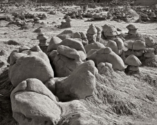 The Goblins gather by the thousands! These "hoodoo rocks" are formations of mushroom-shaped rock pinnacles, some as high as several meters. The distinct shapes of these rocks come from an erosion-resistant layer of rock atop softer sandstone.  Goblin Valley, north of Hanksville, UT.