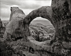 Two arches in a single stone wall.  The large one spans 71 feet frames the fins of Fin Canyon, stacked atop a much smaller 21-foot arch below it, barely visible from this angle.  Arches NP, UT.