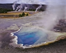 This image taken over 40 years ago in Yellowstone National Park  shows how geysers at that time were beautiful deep blue color.  Today they are green since tourists threw debris into them, causing them to cool, which in turn causes different extremophiles to be in the water.