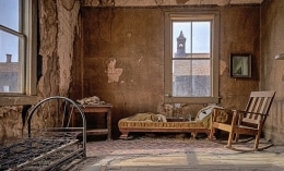 Stains cover the walls. Tattered is the furniture and floor covering.  The years have not been kind.  Bodie Ghost Town, CA.