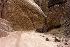 This volcanic ash, called Bentonite, is multicolored and eroding from the hillside further blending to new colors as if upon an artist's palette!  Along the roadside in the Cockscomb Ridge, Utah.