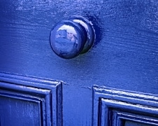 Fresh paint on a door knob reflects my image.  Taken at a shop in St. David's, Wales, Great Britain.