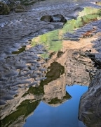 The mud silt forms the frame surrounding a reflection of a Canyonlands National Park "graben".  A graben is a collapsed or down-dropped block of rock that is bordered on its long sides by faults.  "Graben" is German meaning ditch or grave.